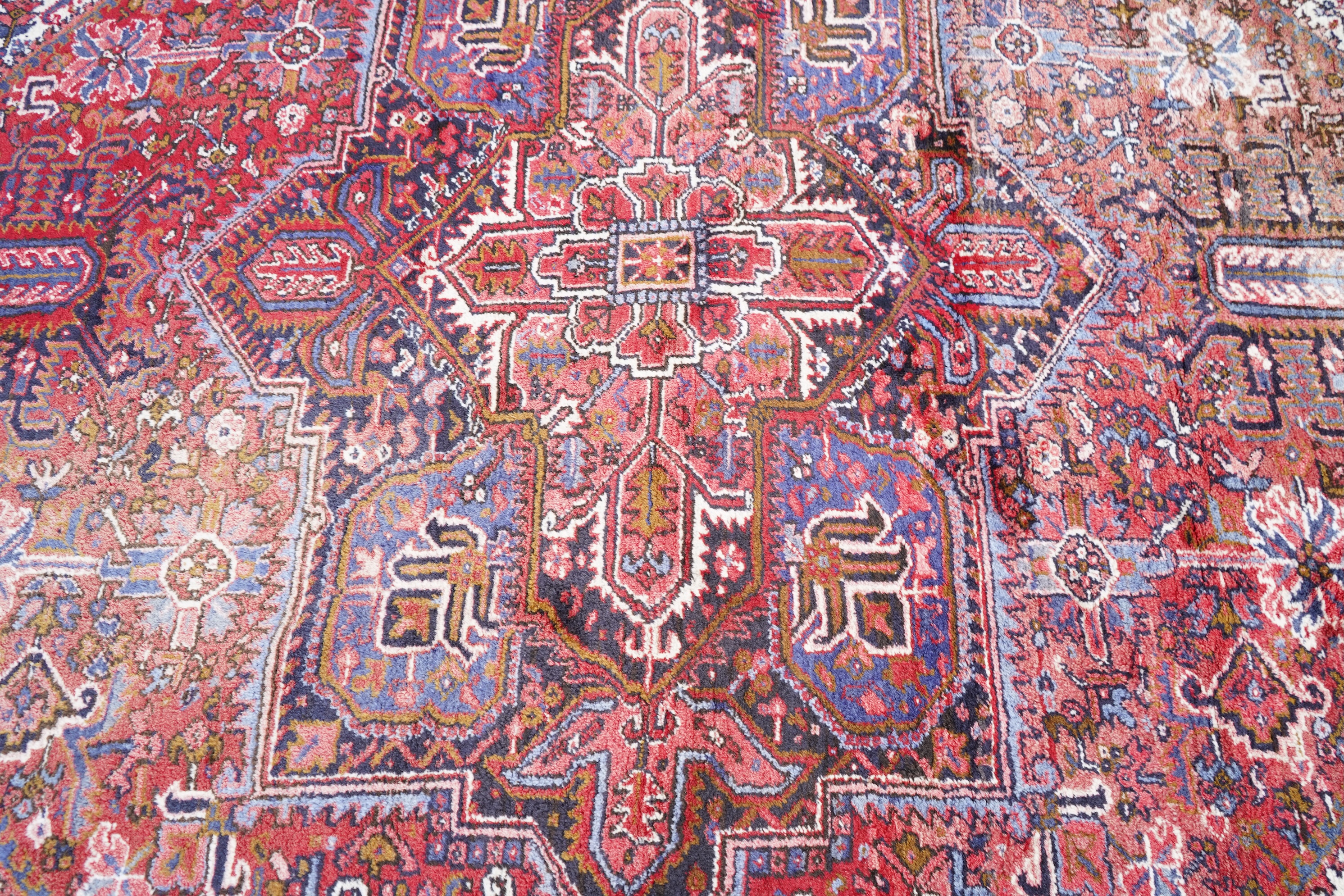 A Heriz brick red ground carpet